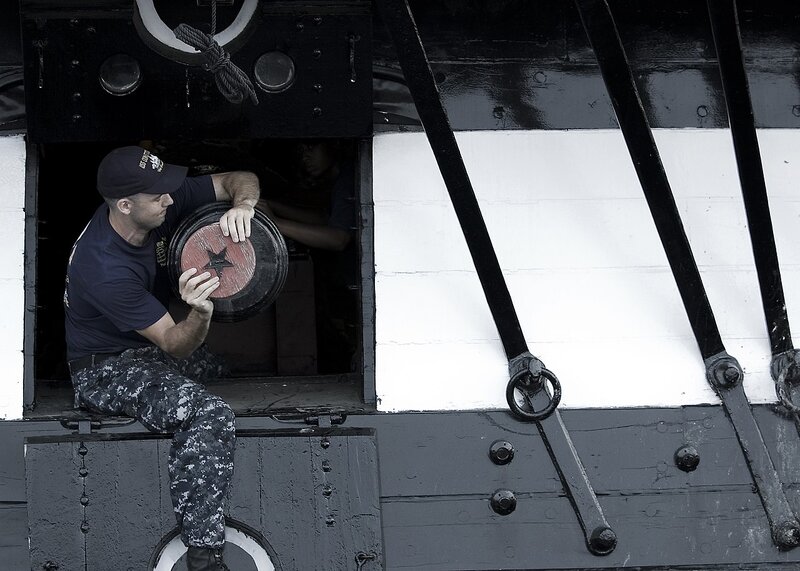 US Navy 090820-N-0167W-039 Machinist's Mate 1st Class Chad Craycraft, a chief petty officer select temporarily assigned to USS Constitution, removes the tampion from a 24-pound long gun aboard Constitution.jpg